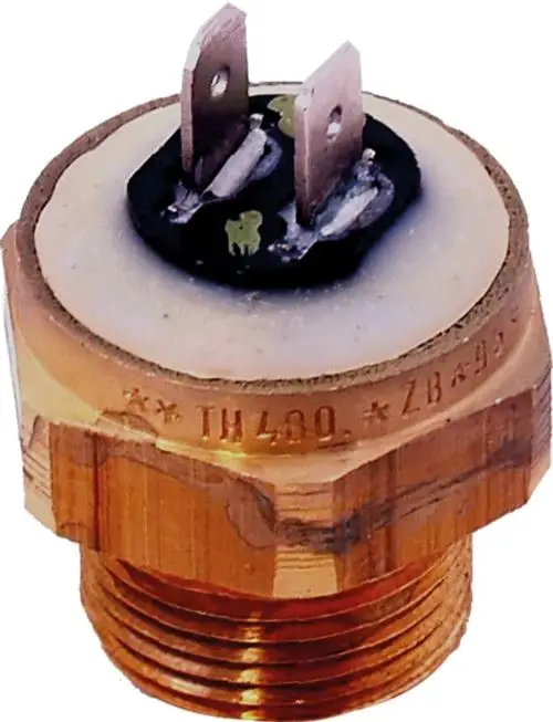 Sicherungsthermostat mit Schraubengewinde und elektrischen Kontakten, verwendet in Pumpenanwendungen. Zu sehen ist die Kunststoffisolierung und das Metallgehäuse, Marke Wolf.